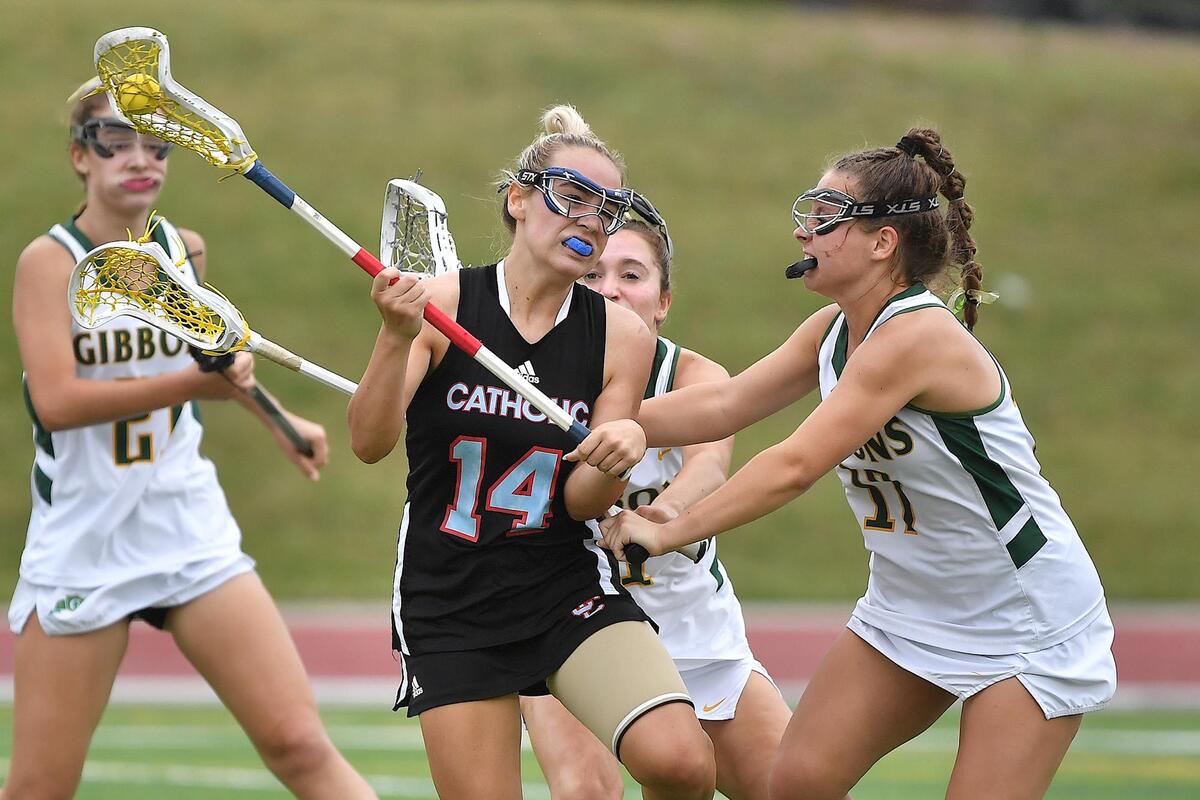 Cardinal Gibbons’ Kate Mullee (17) defends Charlotte Catholic’s Kate Daniels (14) during the second half. The Charlotte Catholic Cougars and the Cardinal Gibbons Crusaders met in the NCHSAA 4A Girls Lacrosse Final in Durham , NC on May 19, 2023.