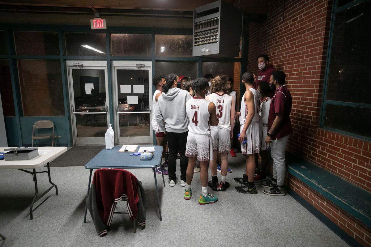 Warren County assistant coach Bryan Fuller addresses the team as they huddle in the lobby of the John Graham Gym during halftime of their game against Webb High School on Friday, January 29, 2021 in Warrenton, N.C. The team is playing their home games in this gym with no locker-rooms while their school gym is renovated. 