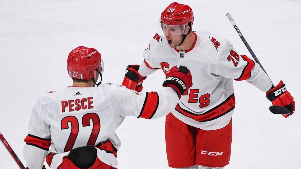 Carolina Hurricanes left wing Mackenzie MacEachern (28) celebrates his goal against the New York Islanders with Carolina Hurricanes defenseman Brett Pesce (22) during the third period in game four of the first round of the 2023 Stanley Cup Playoffs at UBS Arena.