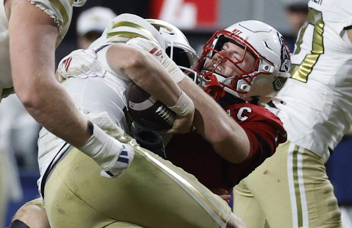 N.C. State linebacker Caden Fordham (1) tackles Georgia Tech quarterback Haynes King (10) during the first half of N.C. State’s game against Georgia Tech at Carter-Finley Stadium in Raleigh, N.C., Saturday, Nov. 1, 2025.