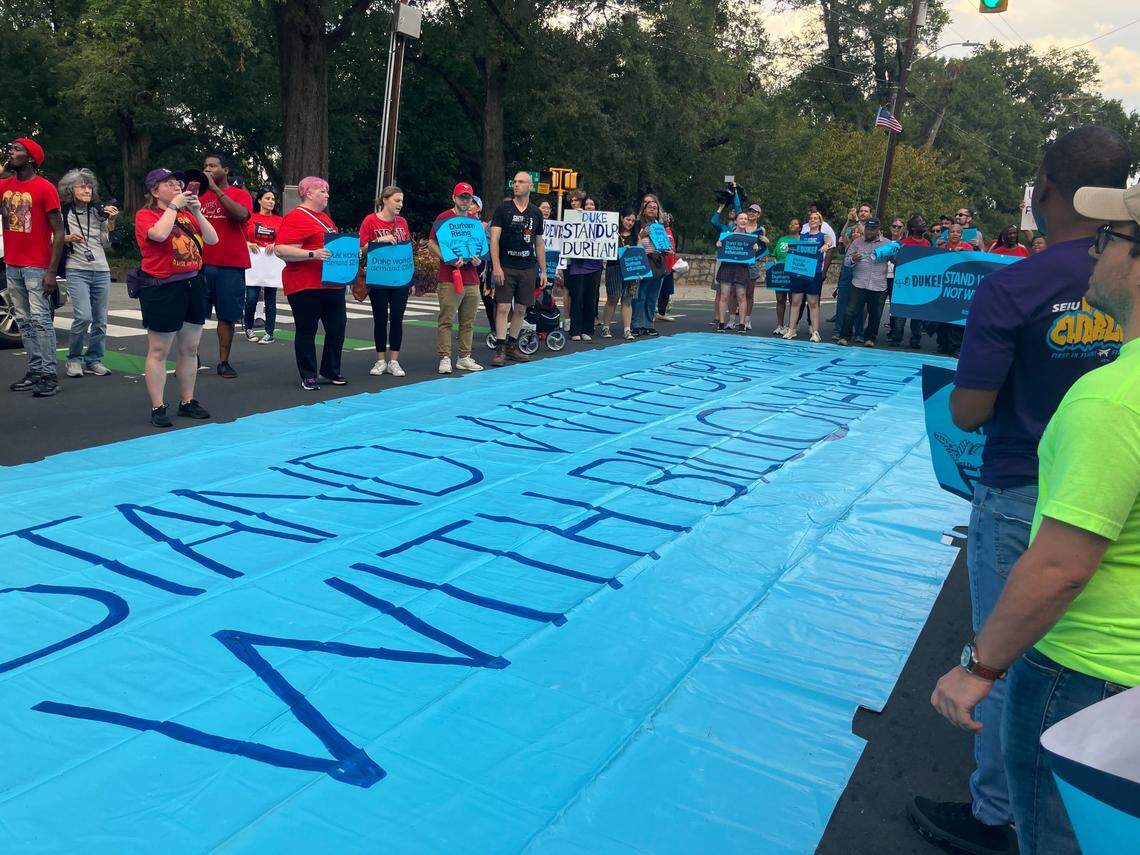 Standing around a banner that says “Duke stand with Durham, not with billionaires,” members of the Durham community took part in a rally Sept. 25, 2025, organized by the Durham Rising coalition, near the Duke University campus. Participants called upon Duke’s administration to invest more into the city and families as well as raise pay for Duke workers.