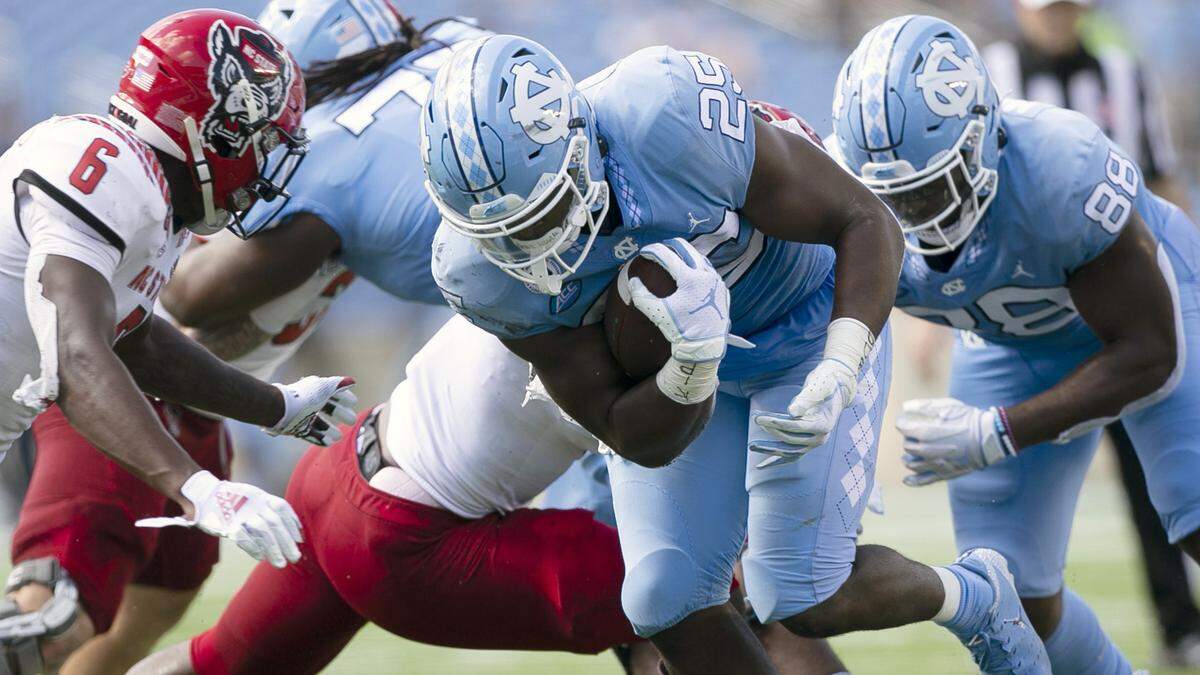 North Carolina’s Javonte Williams (25) rushes for a first down in the second quarter against N.C. State at Kenan Stadium on Saturday, October 24, 2020 in Chapel Hill, N.C.