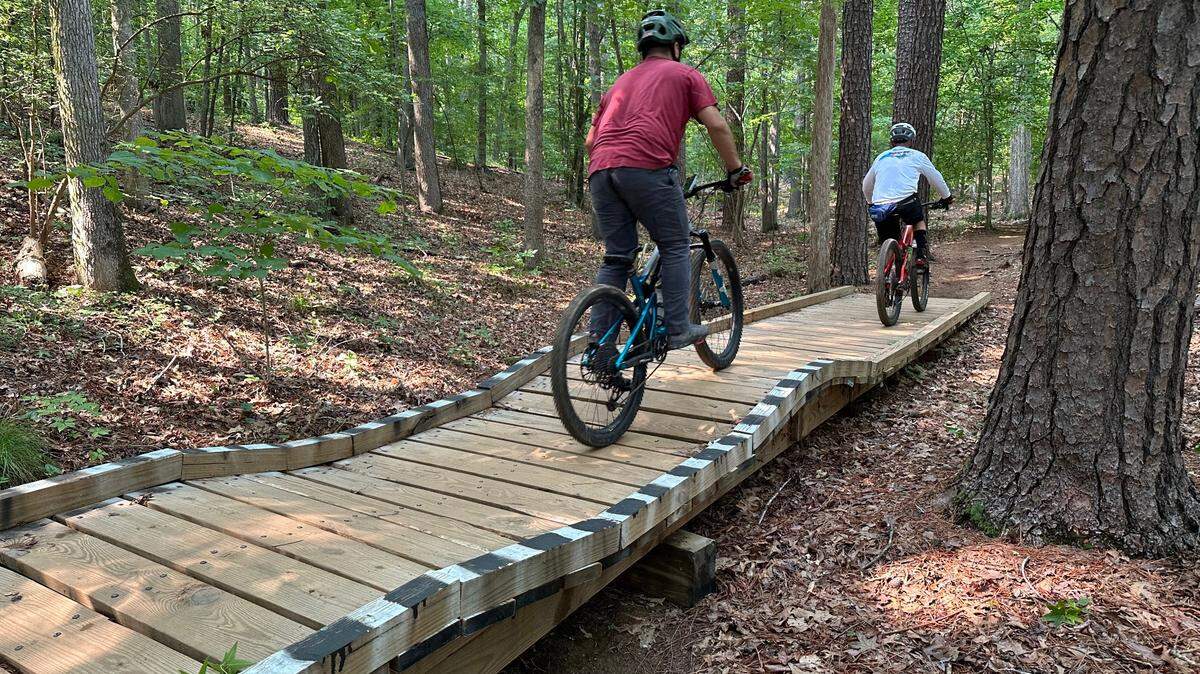 A cyclist on one of the trails in Lake Crabtree County Park, before they were closed to the public in 2025. The county is developing another trail network nearby.