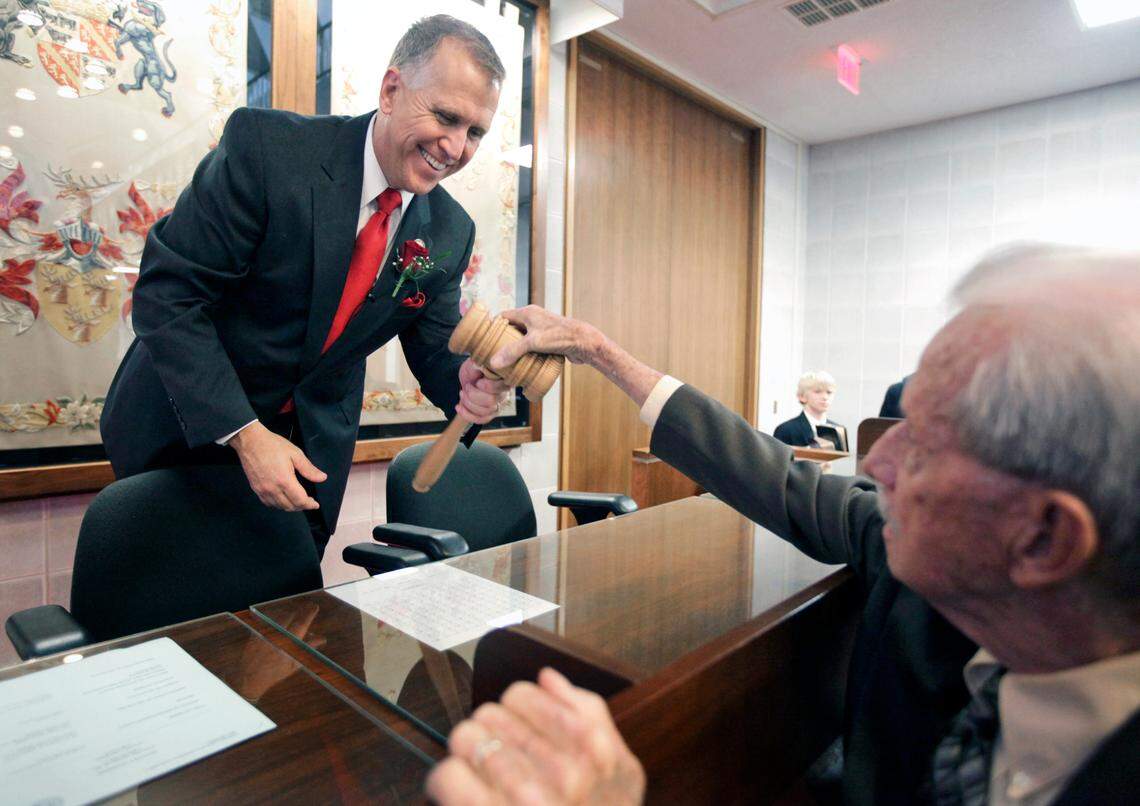 House Speaker Thom Tillis of Mecklenburg County shows off his new pine gavel to Ray Folwell, father of Rep. Dale Folwell, after closing the first day of the session in 2011.