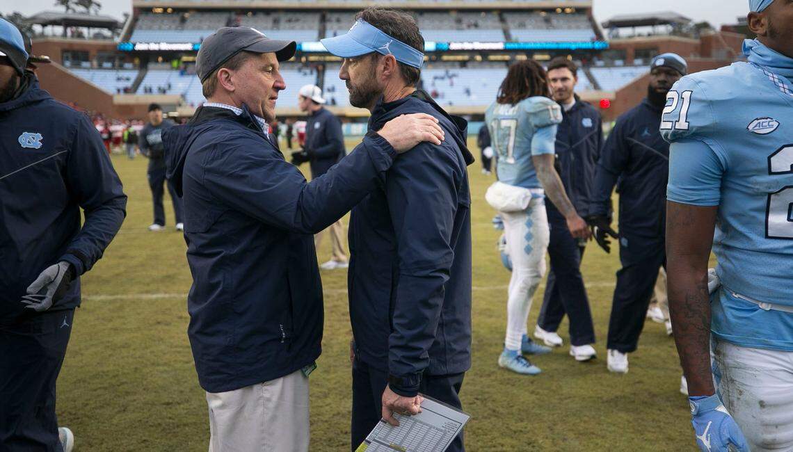 Chuck Duckett, left, talks with North Carolina coach Larry Fedora as he leaves the field following the Tar Heels’ 38-24 loss to N.C. State on Saturday, November 24, 2018 at Kenan Stadium in Chapel Hill, N.C.