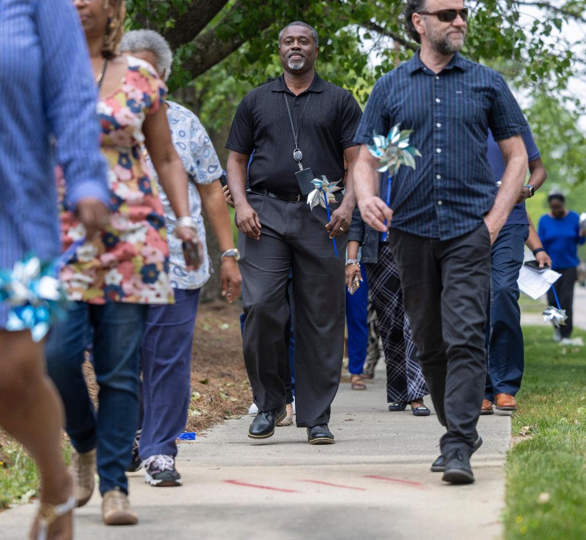 NC Department of Health and Human Services employees and activists marched around a DHHS office Raleigh in April to raise awareness about child abuse.
