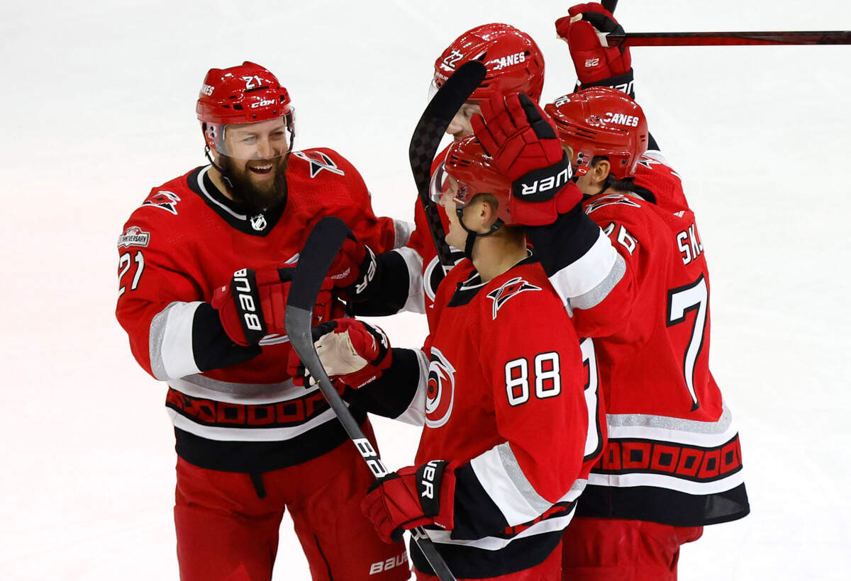 Carolina’s Derek Stepan (21), Brett Pesce (22) and Brady Skjei (76) celebrate with Martin Necas (88) after Necas scored during the third period of the Carolina Hurricanes’ 4-1 victory over the Columbus Blue Jackets at PNC Arena in Raleigh, N.C., Wednesday, Oct. 12, 2022.