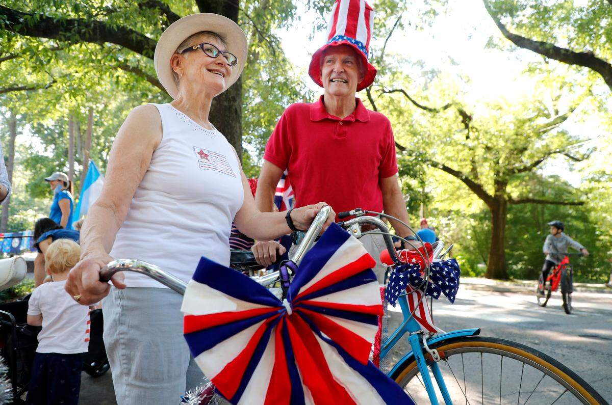 Sally Adkin, left, and her husband Clare prepare to participate in the Watts-Hillandale neighborhood’s 72nd annual Fourth of July parade in Durham, N.C, Sunday, July 4, 2021. 