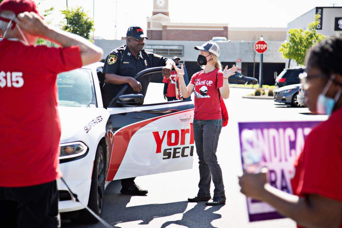 Protestors are asked to leave by security outside of the Wake Forest & Six Forks Starbucks in Raleigh on April 11, 2022, in response to the firing of vocal union leader Sharon Gilman earlier this month.