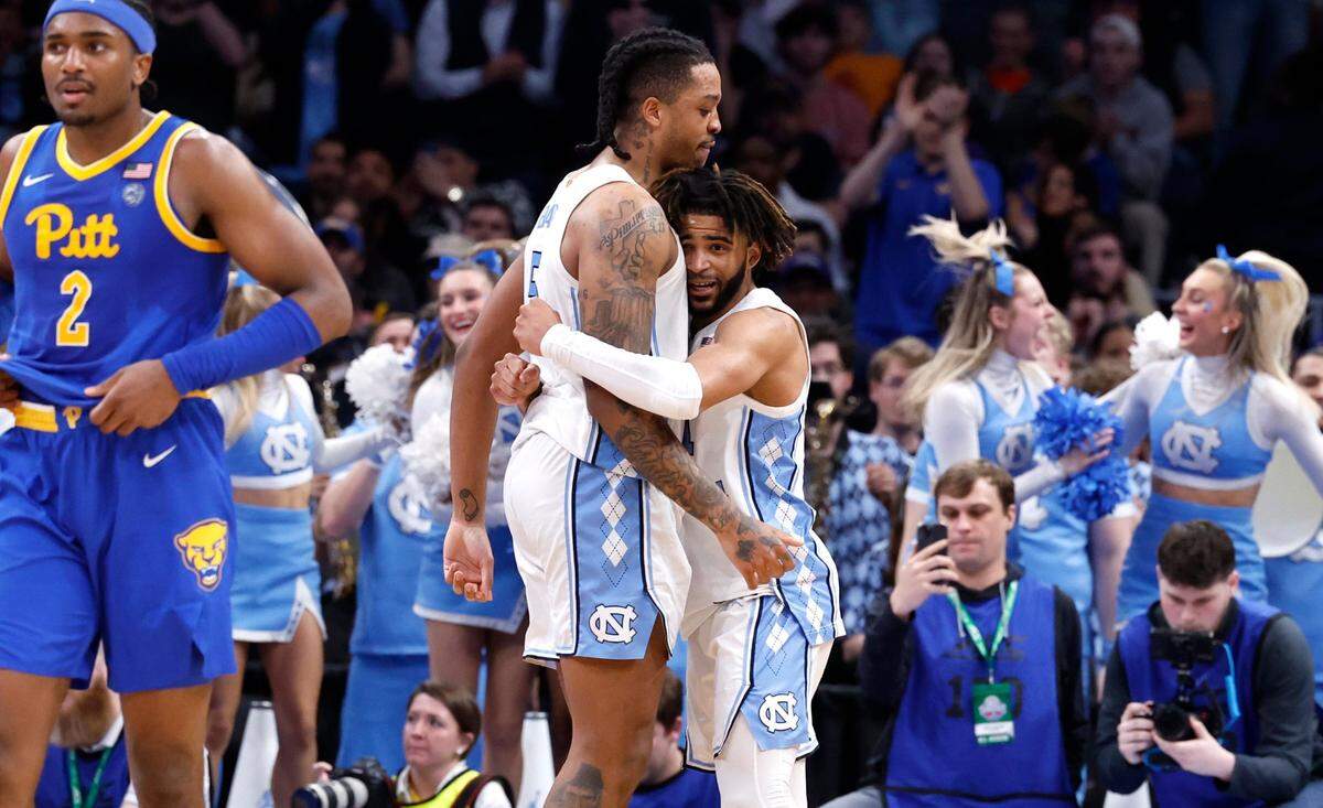 North Carolina’s RJ Davis (4) and Armando Bacot (5) hug as time runs out in UNC’s 72-65 victory over Pitt in the semifinals of the 2024 ACC Men’s Basketball Tournament at Capital One Arena in Washington, D.C., Friday, March 15, 2024.