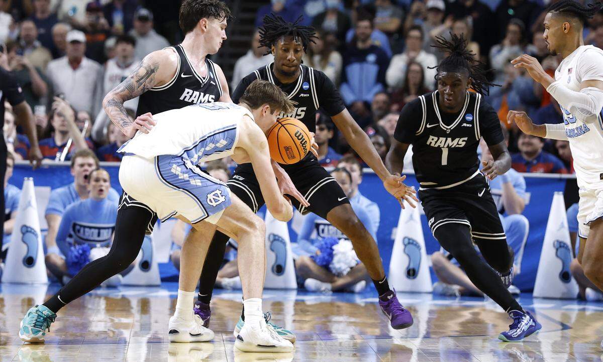 North Carolina's Henri Veesaar (13) loses control of the ball, turning it over, with three seconds left in regulation during VCU’s 82-78 overtime victory over UNC in the first round of the NCAA Men’s Basketball Tournament at  Bon Secours Wellness Arena in Greenville, S.C., Thursday, March 19, 2026.