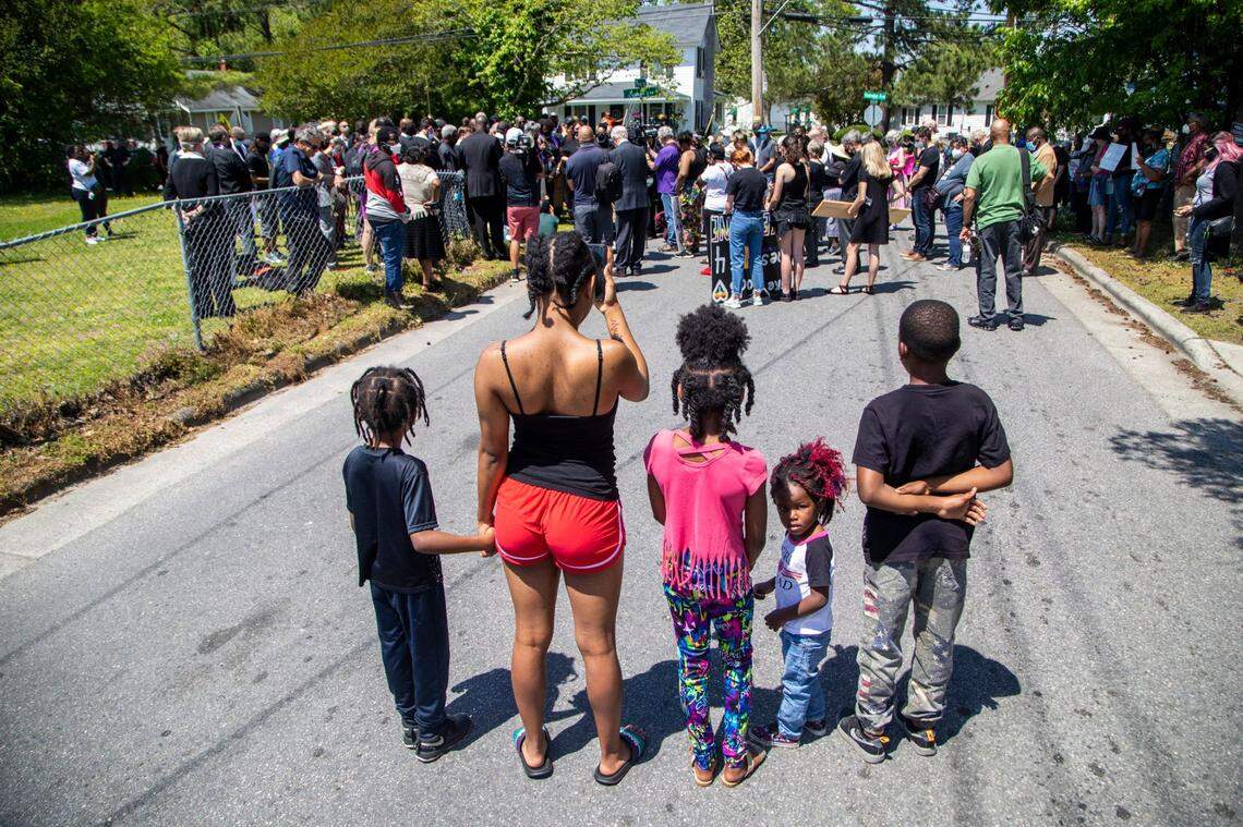 Neighbors of Andrew Brown Jr. watch as demonstrators, led by clergy, rally Wednesday, April 28, 2021 at the site where Brown was shot and killed by Pasquotank County Sheriff deputies. A Pasquotank County judge denied the petition by the media to release the body camera footage in the shooting of Andrew Brown Jr.