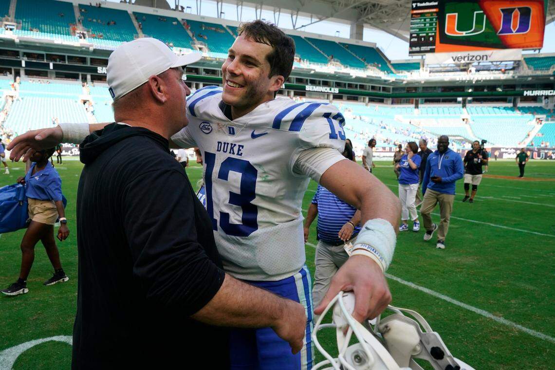 Duke head coach Mike Elko and quarterback Riley Leonard (13) congratulate each other after Duke beat Miami 45-21, in an NCAA college football game, Saturday, Oct. 22, 2022, in Miami Gardens, Fla. (AP Photo/Wilfredo Lee)