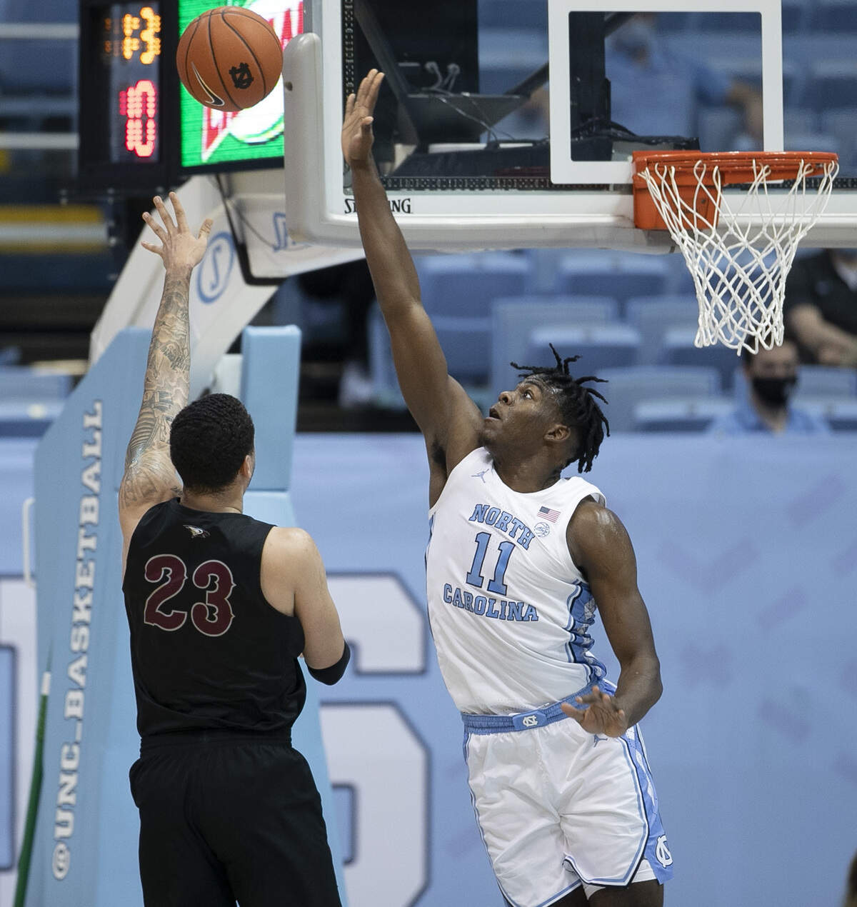 North Carolina’s DayÕRon Sharpe (11) defends NCCU’s Jahnathan Maxwell (23) during the first half on Saturday, December 12, 2020 at the Smith Center in Chapel Hill, N.C.