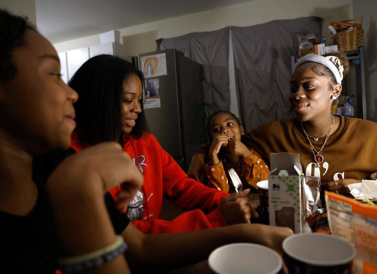 From left, sisters Abby, Sarah, Hannah and Ahava Edgerton share a laugh around the table after eating dinner at their Durham, N.C. home on Wednesday, Oct. 26, 2022.