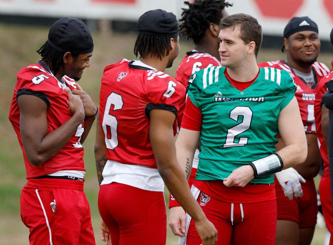 N.C. State quarterback Grayson McCall (2), right, talks with wide receivers Noah Rogers (5) and Wesley Grimes (6) during the Wolfpack’s first spring practice Tuesday, Feb. 27, 2024.