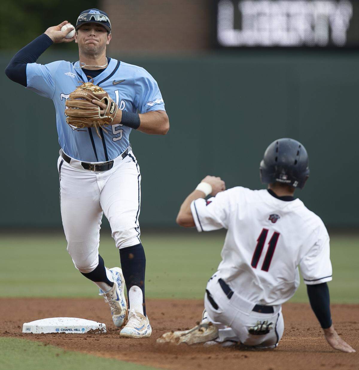 Liberty’s Jonathan Embry (11) is out at second as North Carolina’s Ashton McGee (5) turns a double play in the first inning during the NCAA regional on Saturday, June 1, 2019 at Boshamer Stadium in Chapel Hill, N.C.