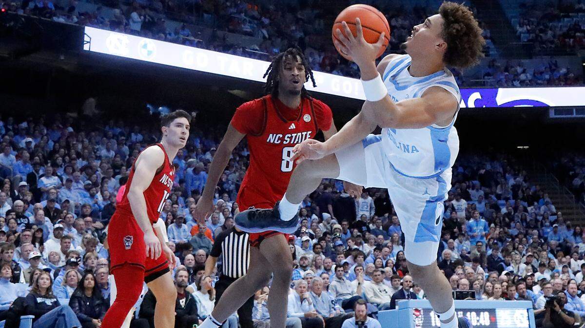 North Carolina’s Seth Trimble drives to the basket around N.C. State’s Jayden Taylor during the first half of the Tar Heels’ 97-73 win on Wednesday, Feb. 19, 2025, at the Smith Center in Chapel Hill, N.C.