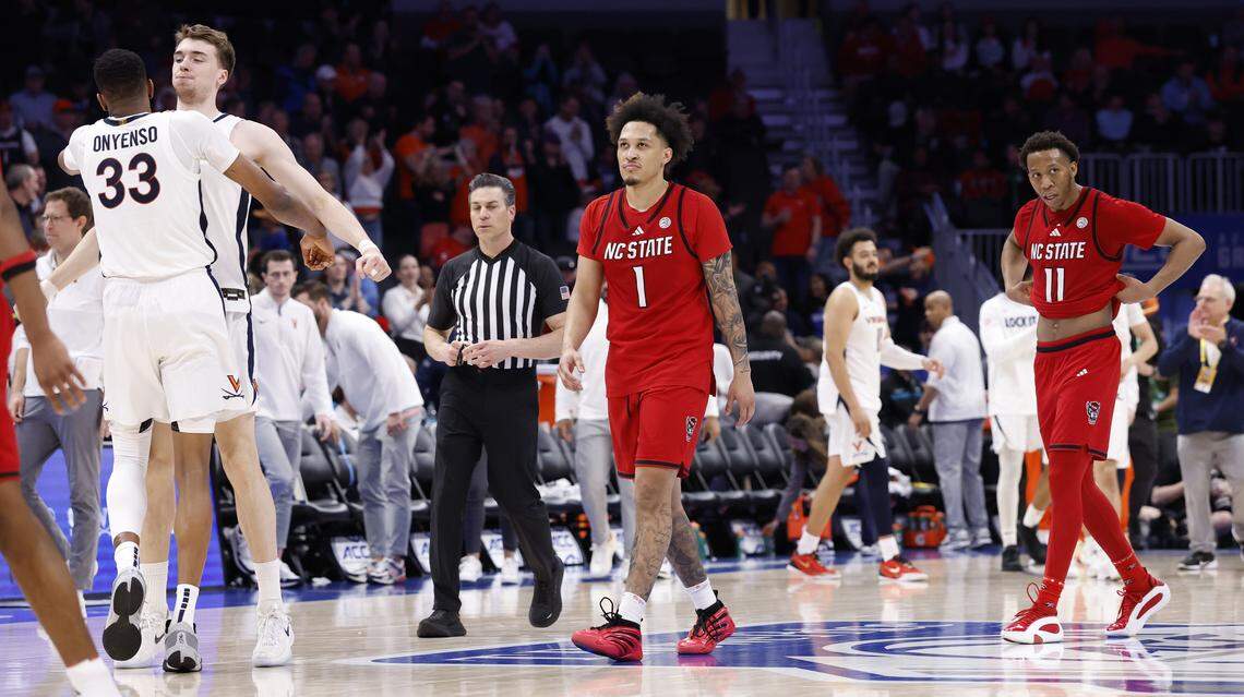 N.C. State's Darrion Williams (1) and Quadir Copeland (11) walk back to the bench after VirginiaÕs 81-74 victory over N.C. State in the quarterfinals of the 2026 ACC MenÕs Basketball Tournament at the Spectrum Center in Charlotte, N.C., Thursday, March 12, 2026.