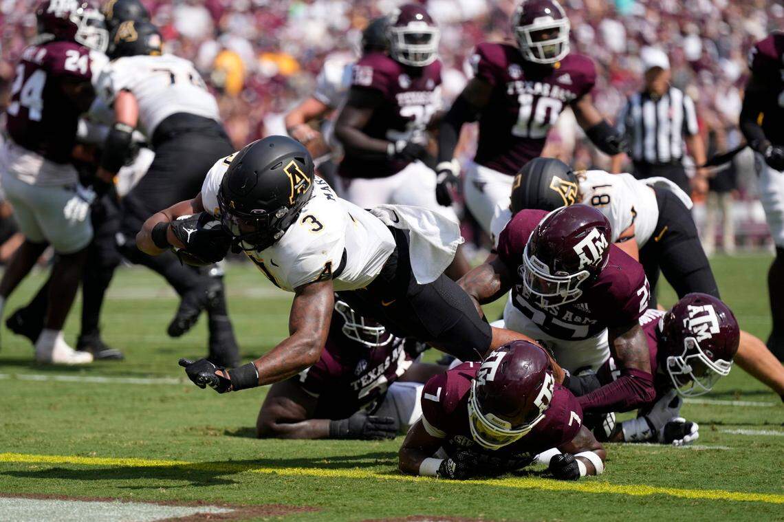 Appalachian State running back Ahmani Marshall (3) dives out of a tackle by Texas A&M defensive back Tyreek Chappell (7) for a touchdown during the first half of an NCAA college football game Saturday, Sept. 10, 2022, in College Station, Texas.