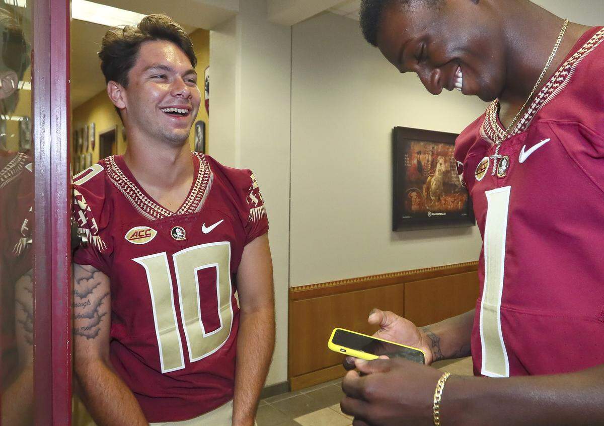 Florida State quarterbacks Bailey Hockman (10) and James Blackman (1) share a laugh after interviews concluded at the NCAA college football media day Sunday, Aug. 19, 2018, in Tallahassee, Fla.