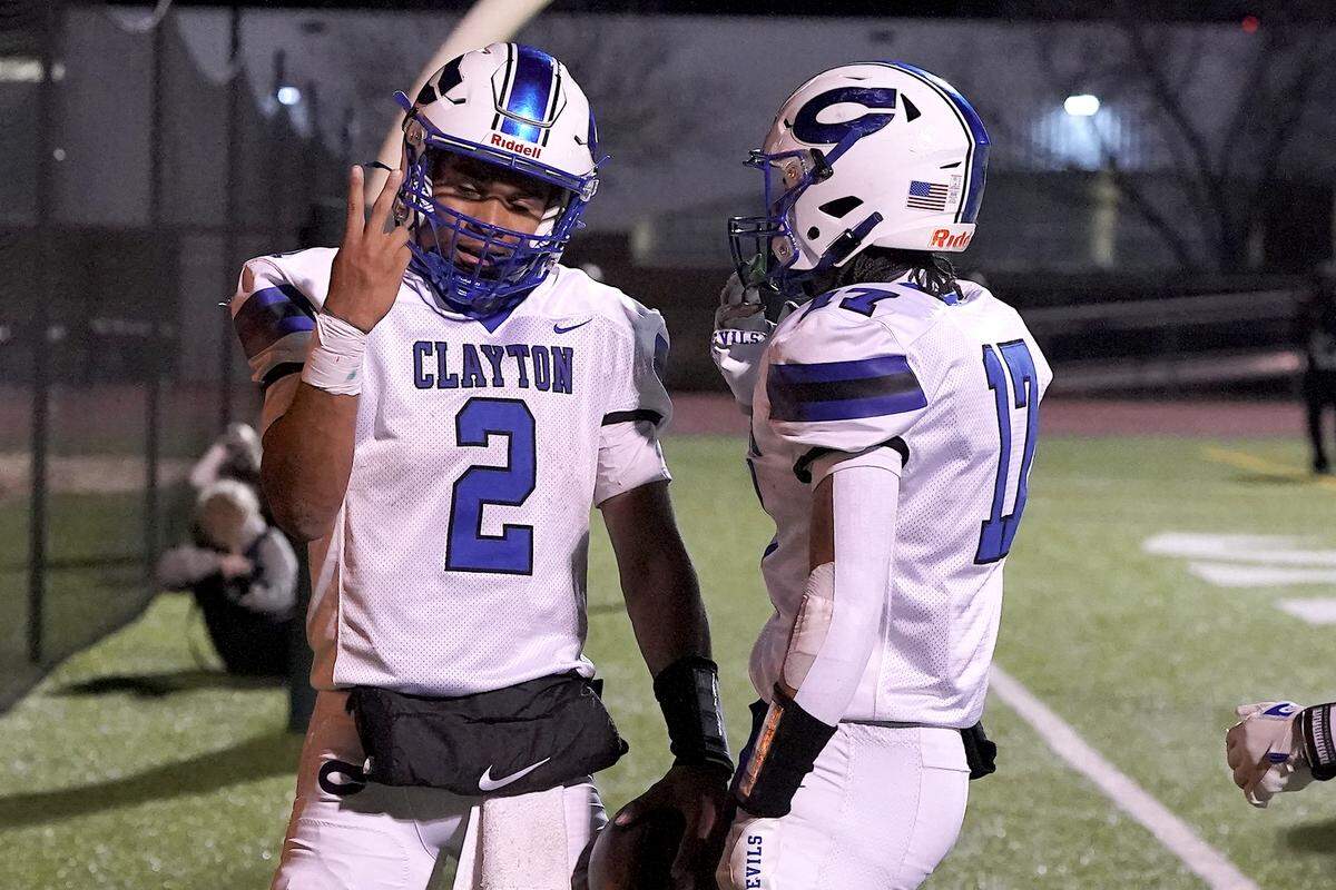 Clayton quarterback Aiden Smalls (2) celebrates his touchdown against Cardinal Gibbons with wide receiver Parker Ferguson (17) during the second half. The Clayton Comets and the Cardinal Gibbons Crusaders met in the East Regional Final of the NCHSAA 7A Football Championship in Clayton, N.C. on December 4, 2025.