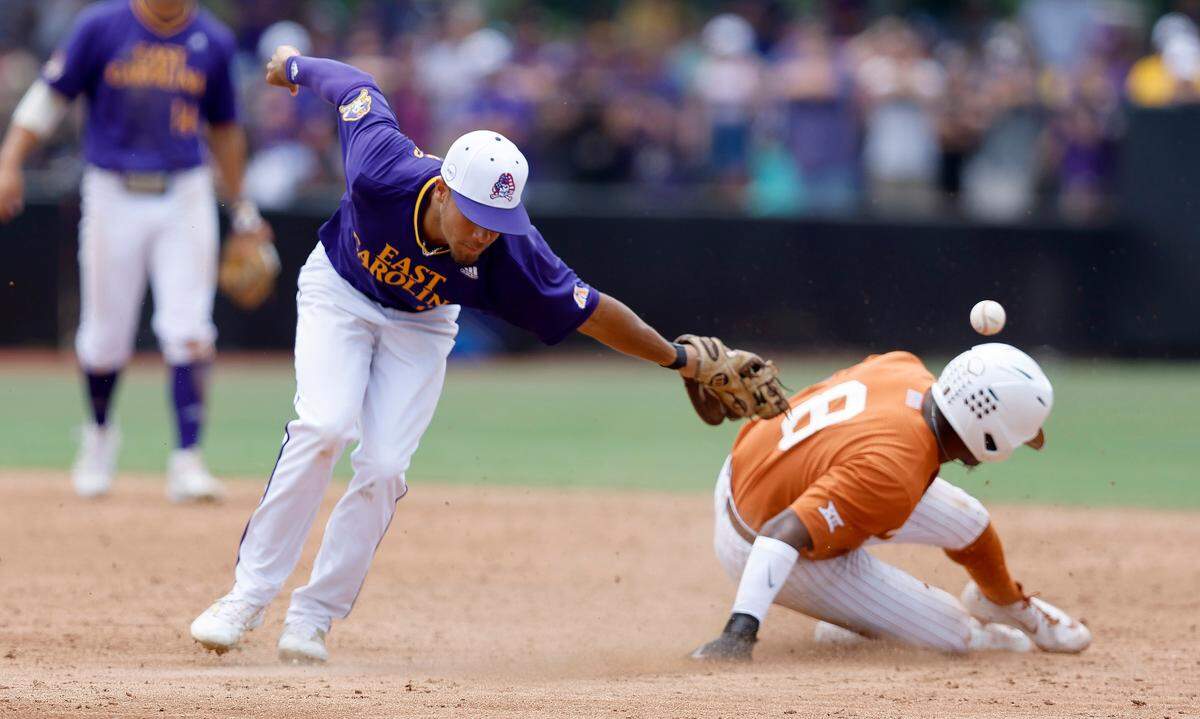 Texas’ Dylan Campbell (8) steals second as East Carolina’s Jacob Starling (10) can’t pull in the throw in the fourth inning during ECU’s game against Texas in the Greenville Super Regional at Clark-LeClair Stadium Saturday, June 11, 2022.