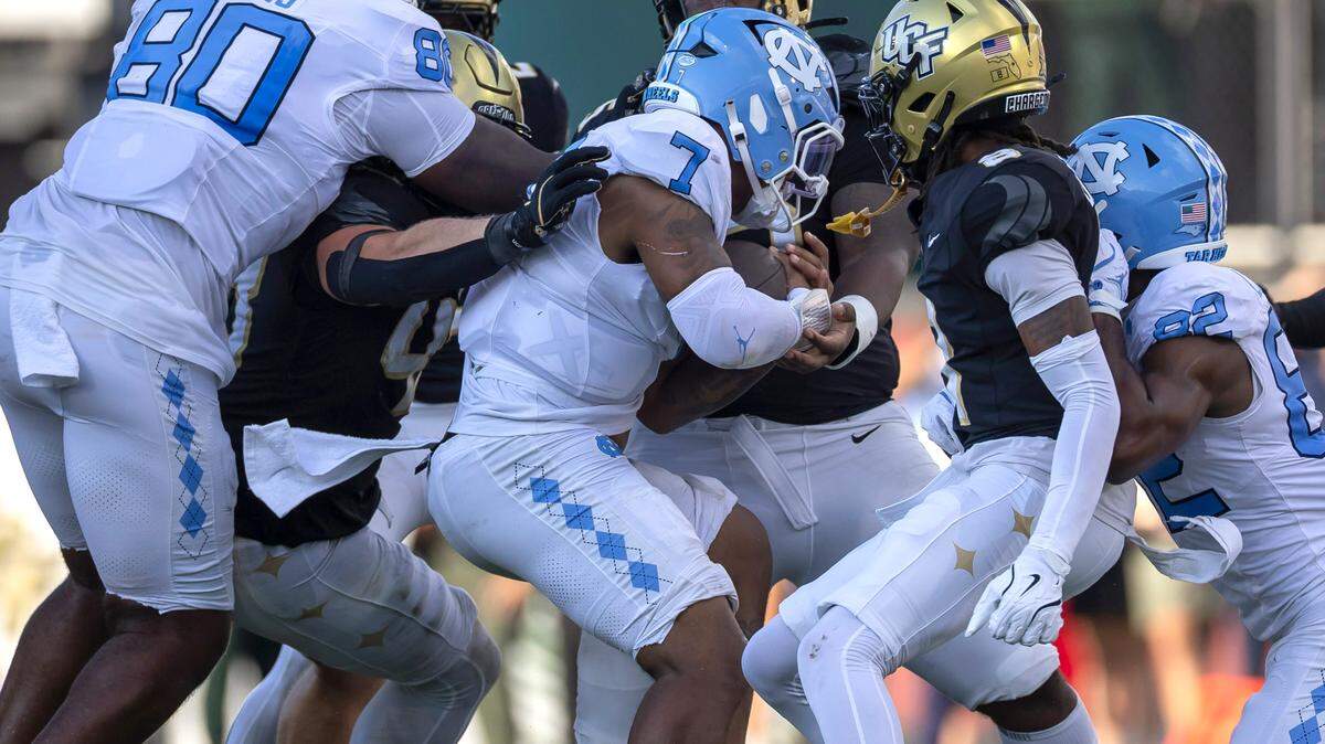 North Carolina quarterback Gio Lopez (7) is stopped by UCF defensive tackle R.J. Jackson Jr. (95) after a gain of one yard for a first down in the third quarter on Saturday, September 20, 2025 in Orlando, Fla. Lopez was injured on the play and did not finish the game.