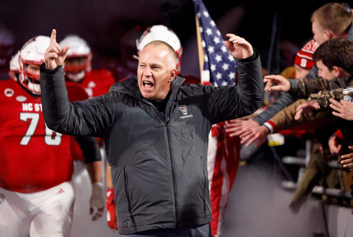 N.C. State head coach Dave Doeren pumps up the crowd as he emerges from the tunnel before the Wolfpack’s game against UNC at Carter-Finley Stadium in Raleigh, N.C., Saturday, Nov. 25, 2023.
