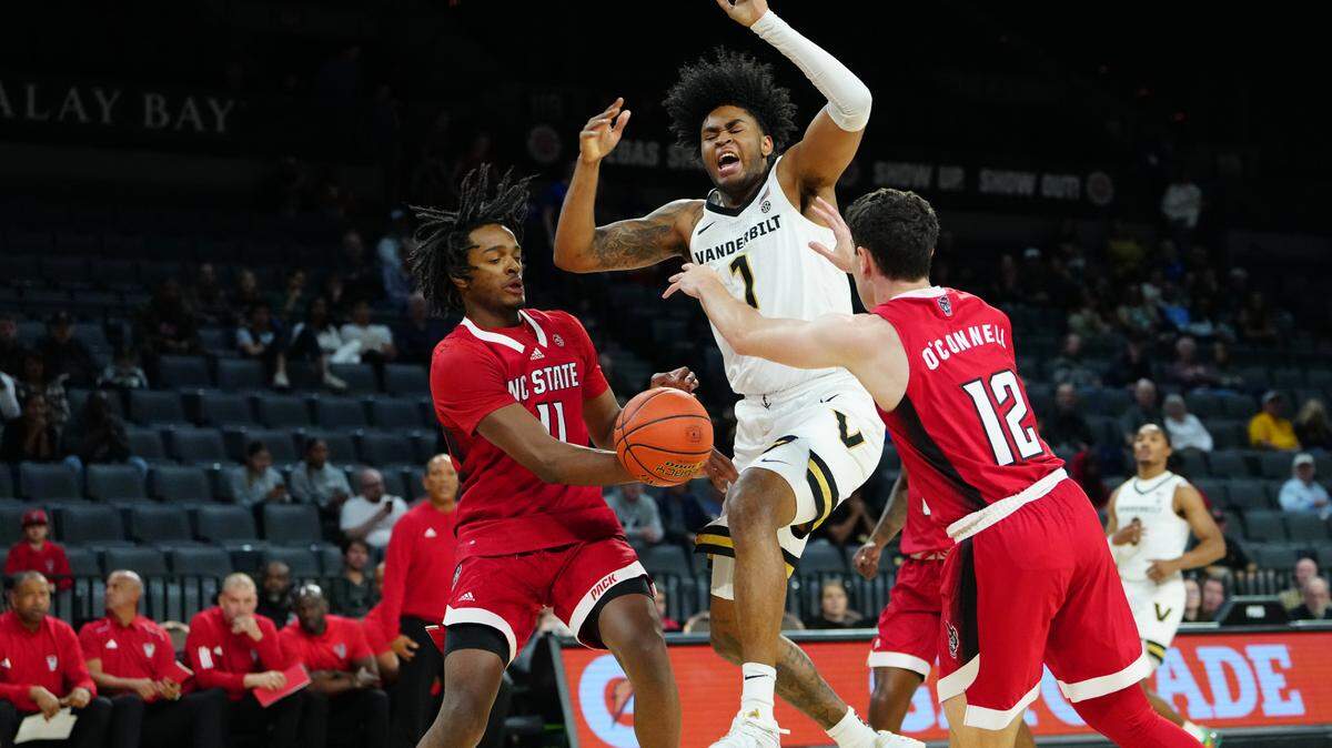 Nov 23, 2023; Las Vegas, Nevada, USA; Vanderbilt Commodores forward Colin Smith (1) loses the ball while shooting against North Carolina State Wolfpack guard Dennis Parker Jr. (11) and North Carolina State Wolfpack guard Michael O’Connell (12) during the first half at Michelob Ultra Arena. Mandatory Credit: Stephen R. Sylvanie-USA TODAY Sports