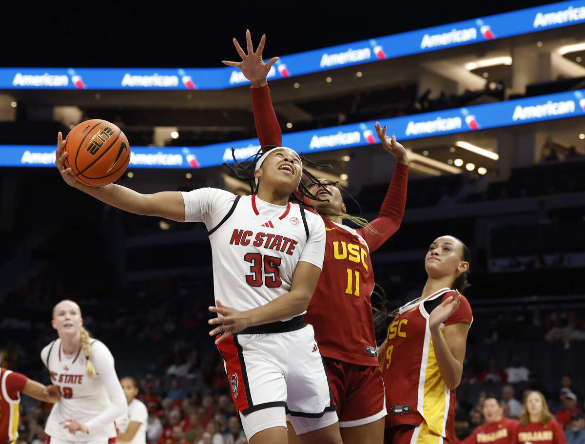 NC State Wolfpack guard Zoe Brooks drives to the basket past Southern California’s Kennedy Smith during the first half of the Wolfpack’s 69-68 loss in the Ally Tipoff game on Sunday, Nov. 9, 2025, at Spectrum Center in Charlotte, N.C.