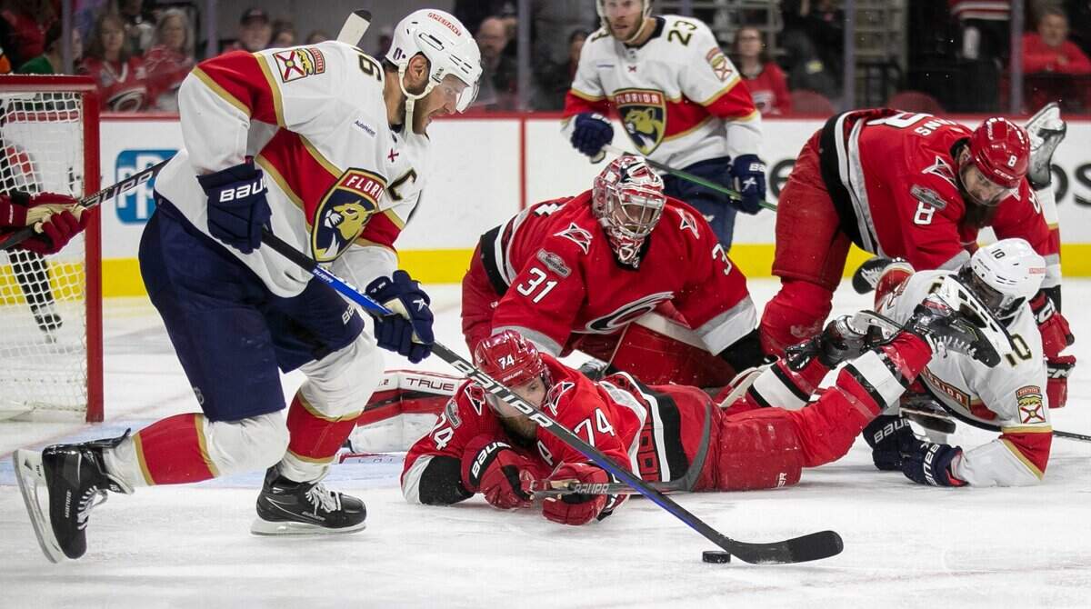 The Florida Panthers Aleksander Barkov (16) rebounds the puck after a scoring attempt in front Carolina Hurricanes goalie Frederik Andersen (31) and Jaccob Slavin (74) of during the first overtime period in Game 1 of the Eastern Conference Finals on Thursday, May 18, 2023 at PNC Arena in Raleigh, N.C.
