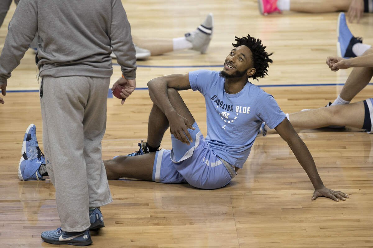 North Carolina’s Leaky Black (1) talks with strength and conditioning coordinator Jonas Sahratian as he stretches prior to practice on Monday, March 9, 2020 at the Greensboro Coliseum in Greensboro, N.C.