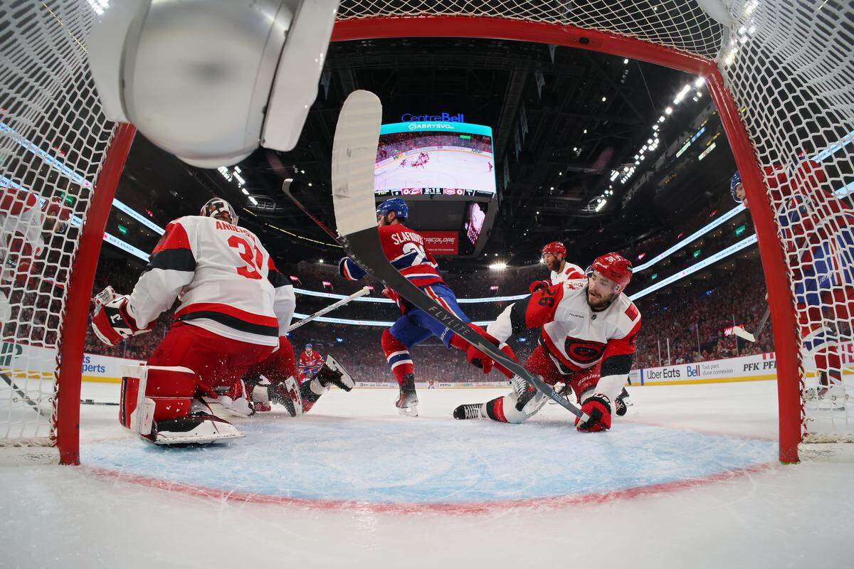 Frederik Andersen #31 and Sean Walker #26 of the Carolina Hurricanes defends the net against against Juraj Slafkovsky #20 of the Montreal Canadiens during the first period in Game Four of the Eastern Conference Final of the 2026 Stanley Cup Playoffs at Bell Centre on May 27, 2026 in Montreal, Quebec, Canada. 