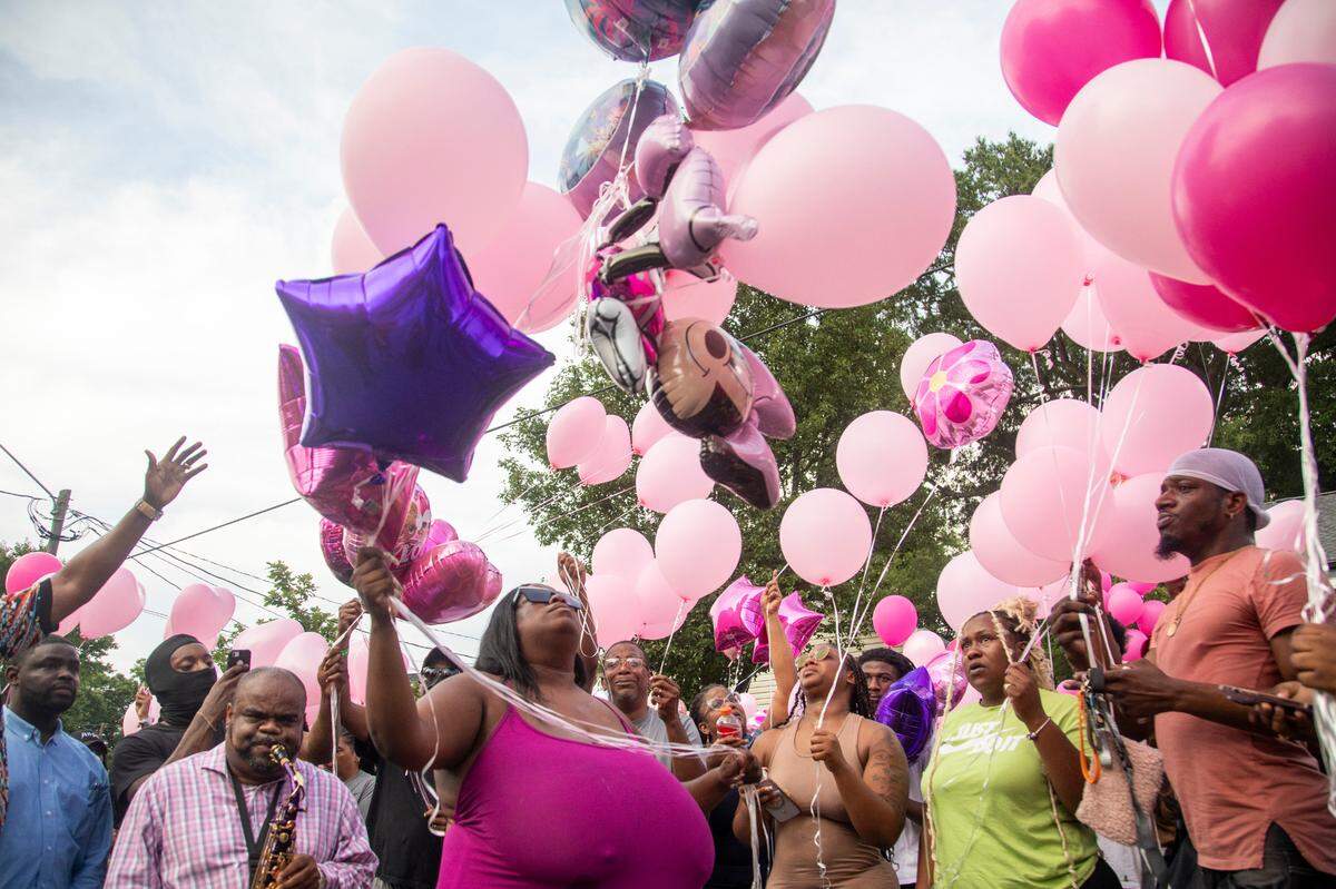 Brittany Dash, the mother of 5-year-old Khloe Fennell, center, releases balloons with family, friends and neighbors during a vigil Friday, July 7, 2023 in Durham. Khloe was shot and killed on Wednesday. Her 15-year-old cousin was babysitting her. She was shot multiple times and survived.