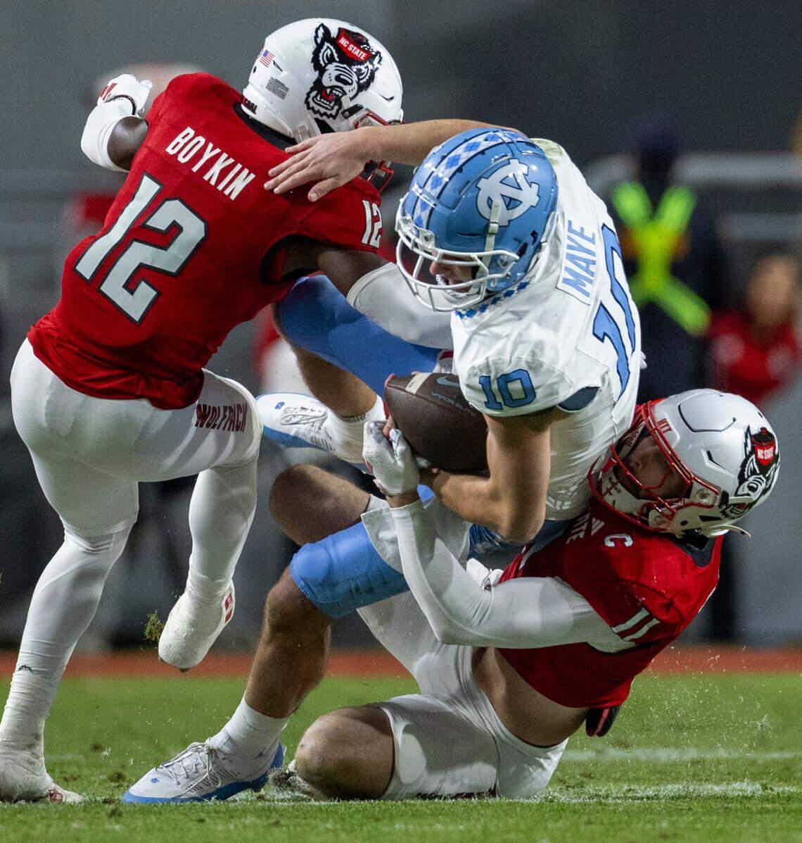 N.C.State linebacker Payton Wilson (11) stops North Carolina quarterback Drake Maye (10) in the first quarter on Saturday, November 25, 2023 at Carter-Finley Stadium in Raleigh, N.C.