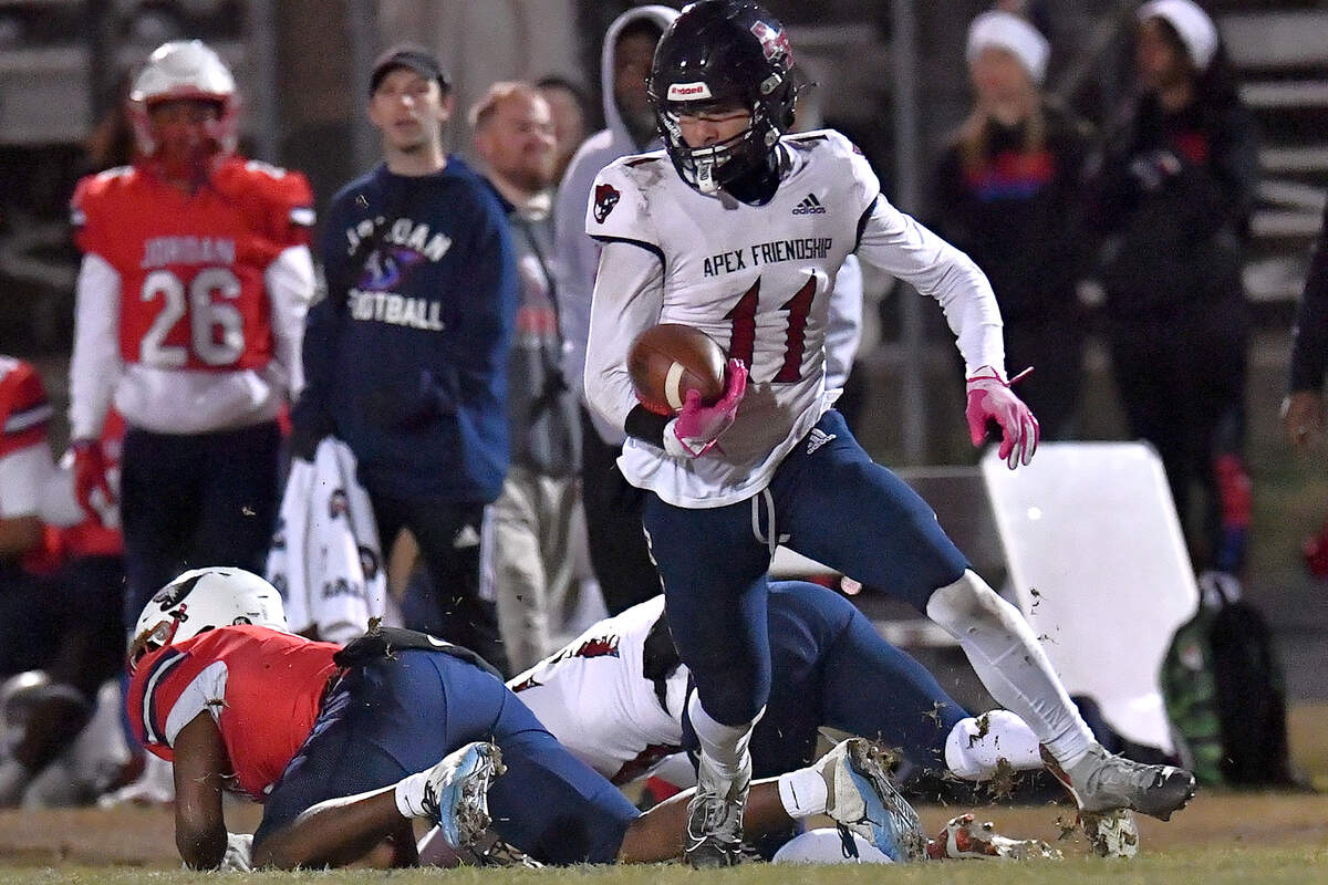 Apex Friendship’s David Lozada (11) runs with the ball after making the interception against Jordan during the first half. The Apex Friendship Patriots and the Durham Jordan Falcons met in the second round of the NCHSAA 4A playoffs in Durham, N.C. on November 22, 2024. The Apex Friendship Patriots and the Durham Jordan Falcons met in the second round of the NCHSAA 4A playoffs in Durham, N.C. on November 22, 2024.