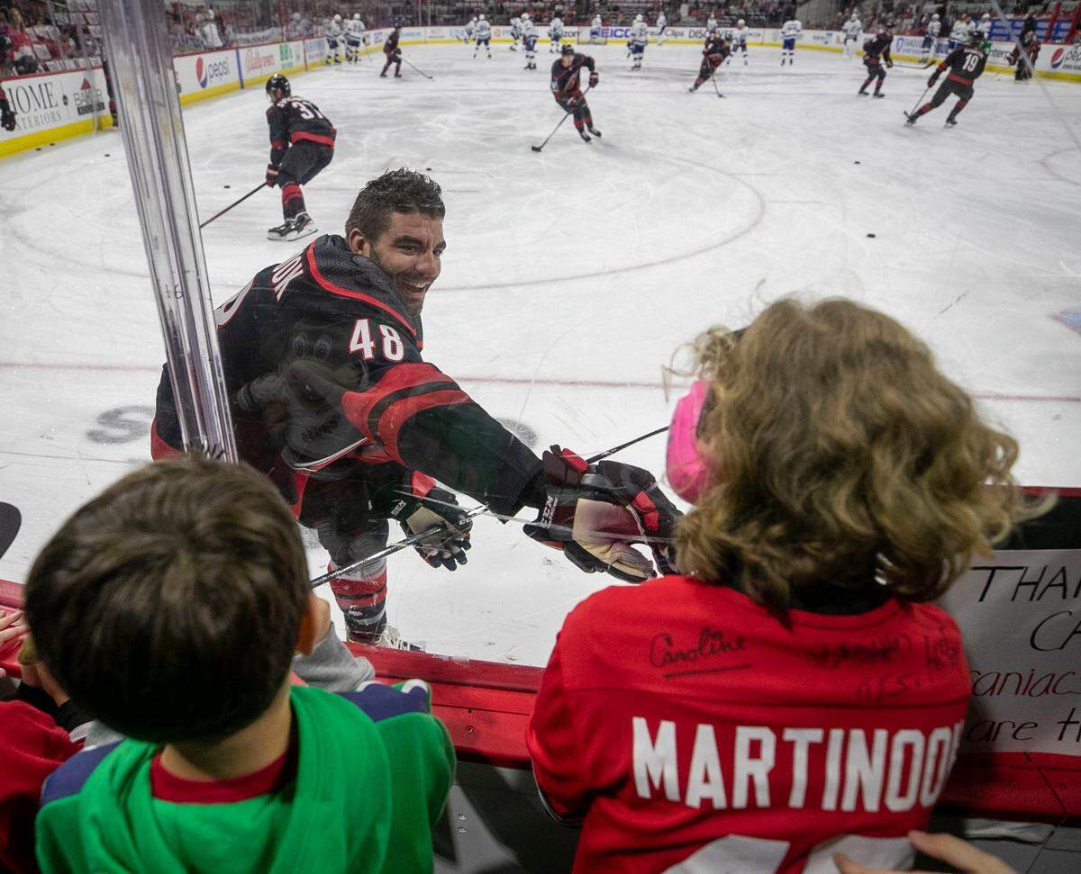 Carolina Hurricane’s Jordan Martinook greets twelve-year-old daughter Emma Izzo of New Bern, N.C. during the Hurricanes’ pre-game warm up on Sunday, May 30, 2021 at PNC Arena in Raleigh, N.C.