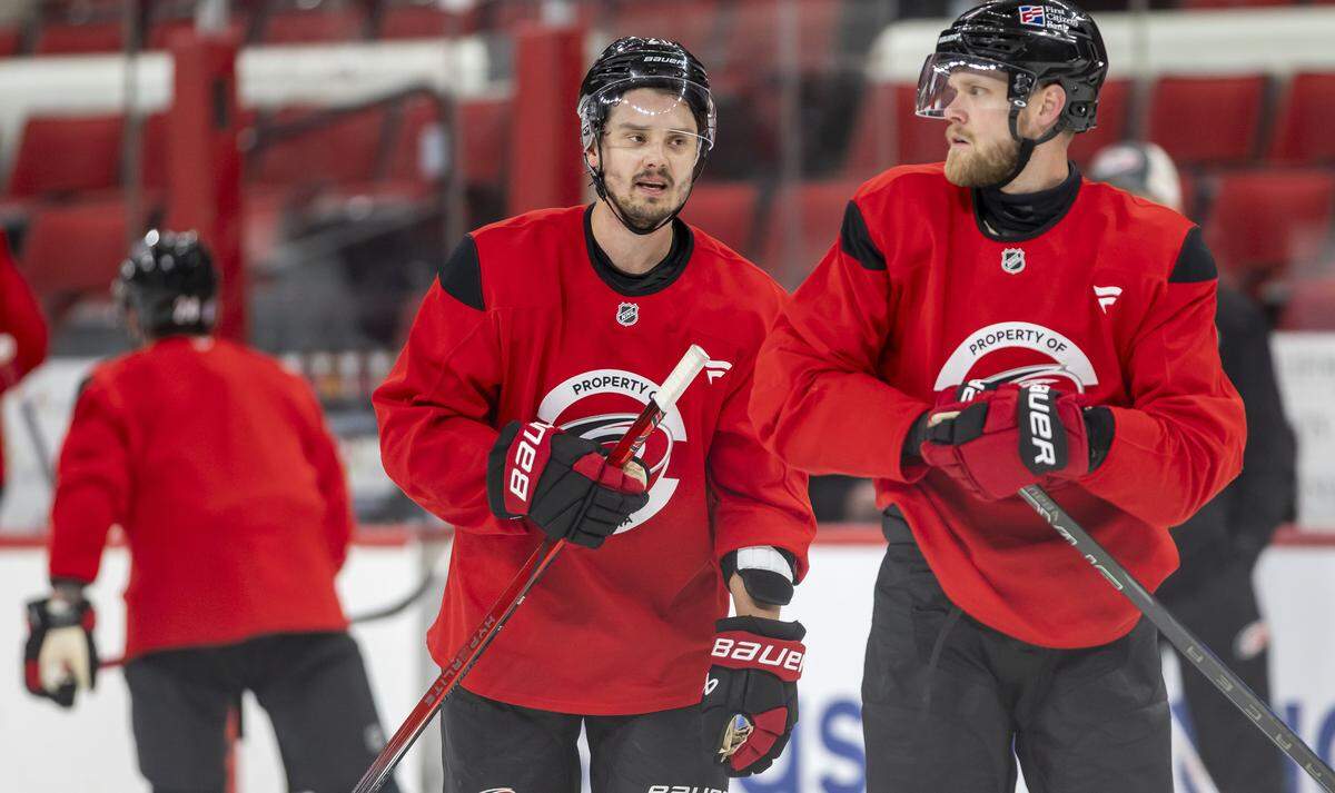 Carolina Hurricanes center Sebastian Aho (20) talks with left wing Nikolaj Ehlers (27), during practice on Friday, May 15, 2026 at Lenovo Center in Raleigh, N.C.