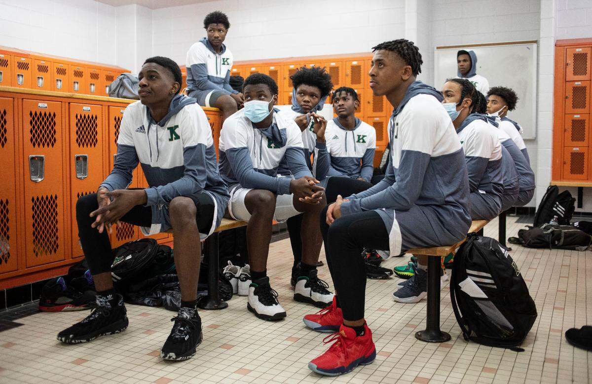 Members of the Kinston High School varsity boy’s basketball team listen to their coach before the start of their game against Southwest Onslow High School in Jacksonville, N.C. on Jan. 5, 2022.