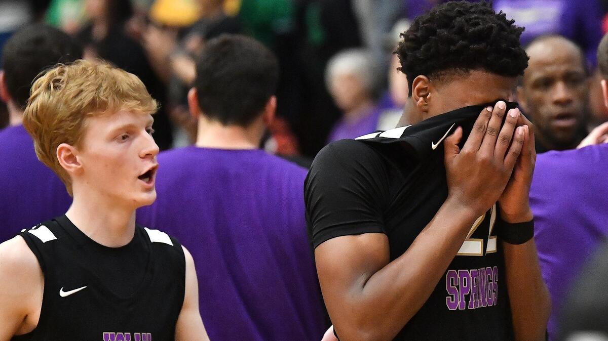 Holly Springs’ Timmy Dumas (2) consoles teammate Will James (22) after their loss to Richmond in the East Regional Finals. The Richmond Raiders and the Holly Springs Golden Hawks met in the NCHSAA 4A East Regional Finals in Sanford, N.C. on March 4, 2023.