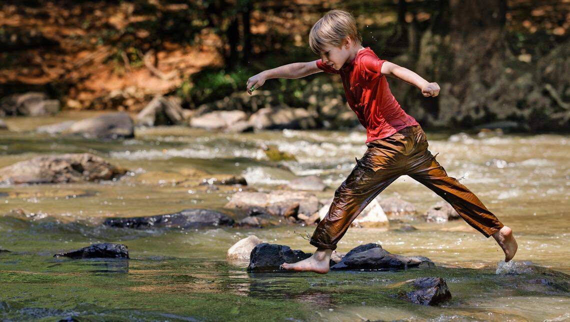 Jonathan Terrell, 10, jumps from a rock in the Eno River on Thursday, July 3, 2025, in Durham, N.C. 