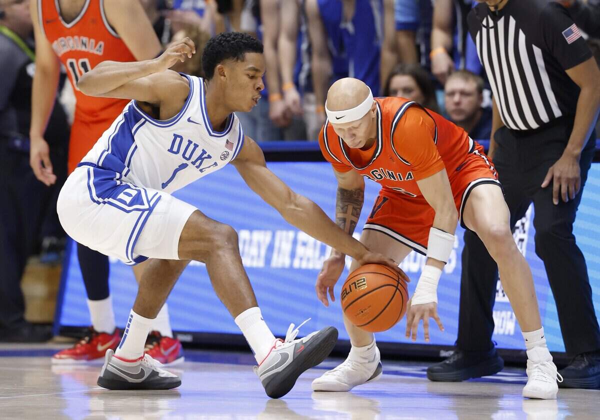 Duke’s Caleb Foster (1) knocks the ball from Virginia's Jacari White (6) during the first half of Duke’s game against Virginia at Cameron Indoor Stadium in Durham, N.C., Saturday, Feb. 28, 2026.