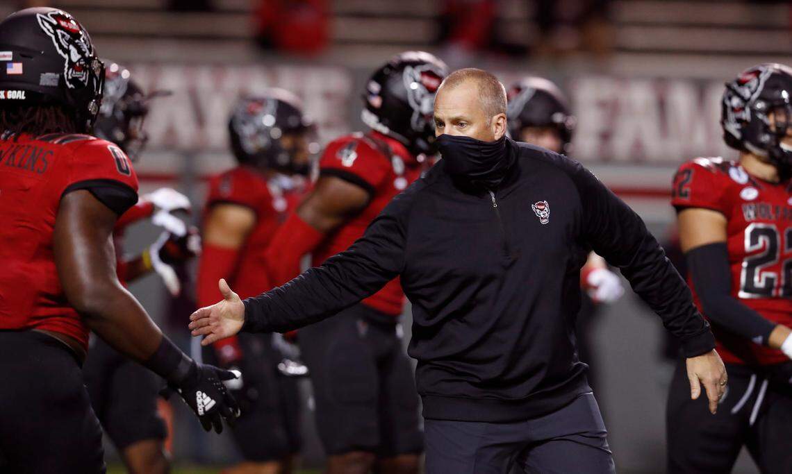 N.C. State head coach Dave Doeren encourages Terrell Dawkins (0) during warmups before N.C. State’s game against Florida State at Carter-Finley Stadium in Raleigh, N.C., Saturday, Nov. 14, 2020.