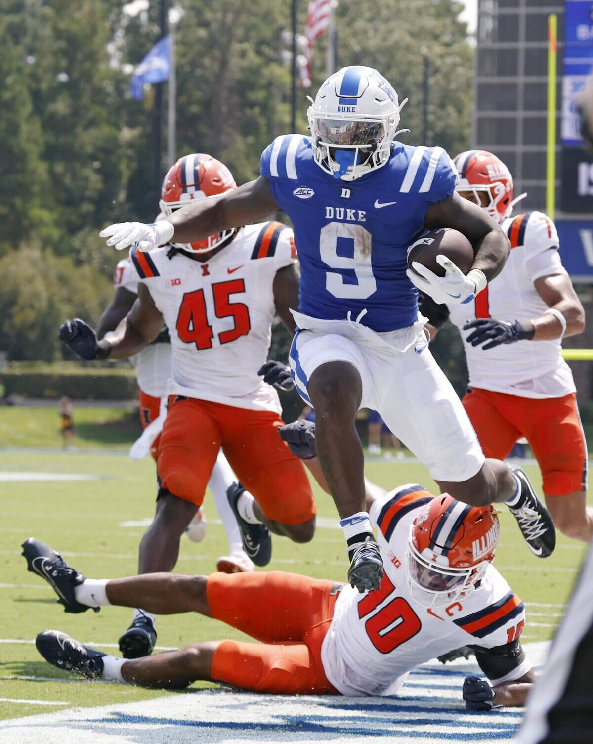 Duke’s Jaquez Moore jumps out of bounds over Illinois’ Miles Scott during the first half of the Blue Devils’ game on Saturday, Sept. 6, 2025, at Wallace Wade Stadium in Durham, N.C.