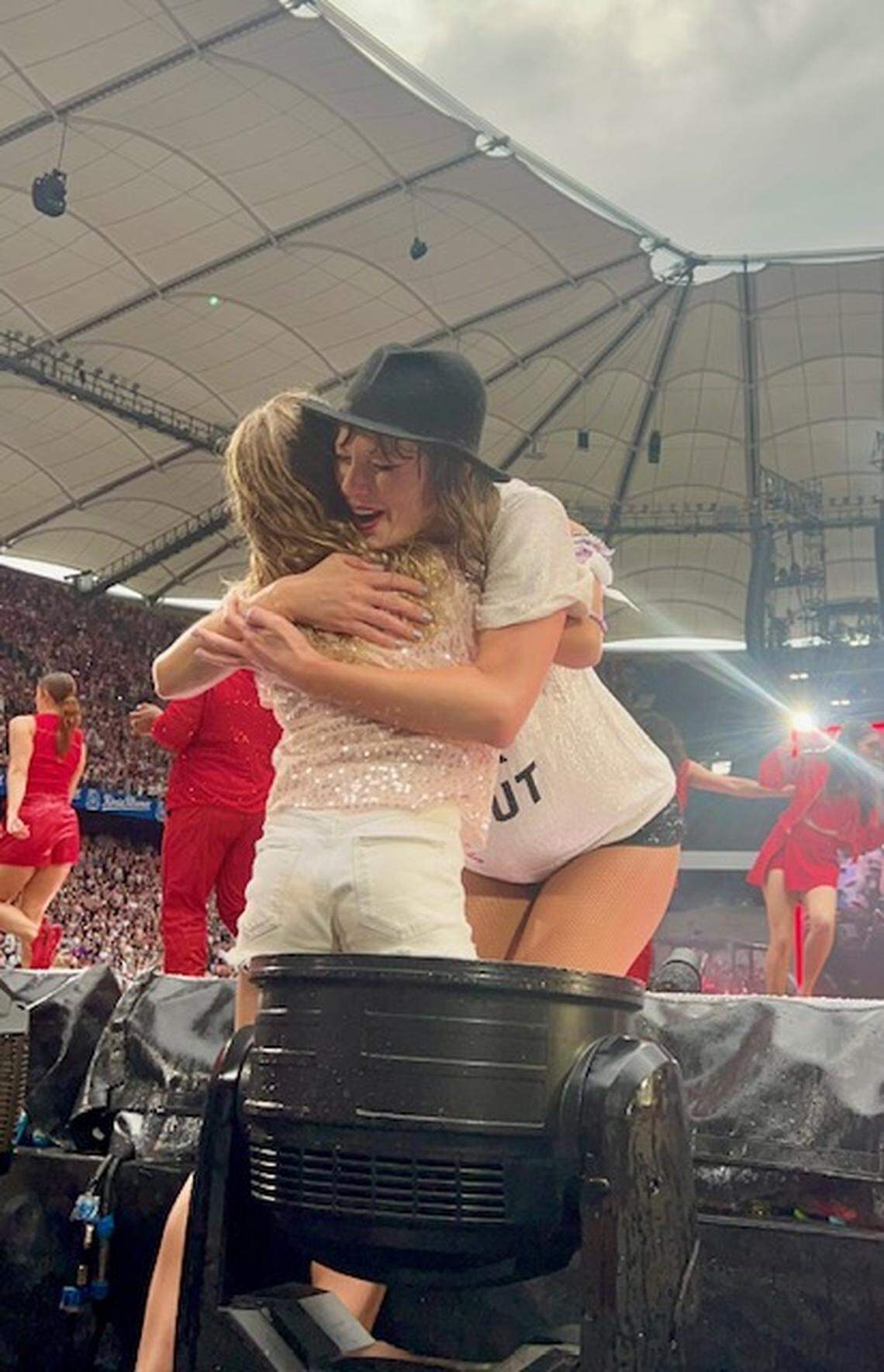 Taylor Swift hugs Lucia Nova Hugelmeyer at Taylor Swift’s Eras Tour stop in Hamburg, Germany on July 23, 2024. Swift gave the Chapel Hill, NC girl a hat during “22.”