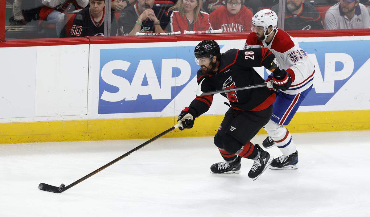 Carolina's William Carrier (28) brings the puck up ice past Montréal's Noah Dobson (53) during the first period of the Hurricanes’ game against the Canadiens in game five of the Eastern Conference Finals at the Lenovo Center Friday, May 29, 2026.