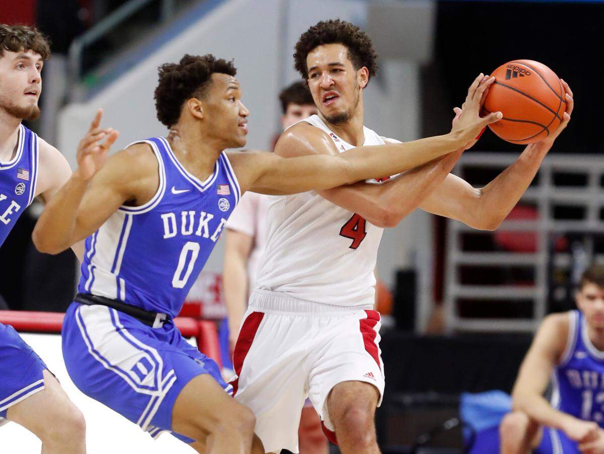 Duke’s Wendell Moore Jr. (0) pressures N.C. State’s Jericole Hellems (4) during the first half of N.C. State’s game against Duke at PNC Arena in Raleigh, N.C., Saturday, February 13, 2021.