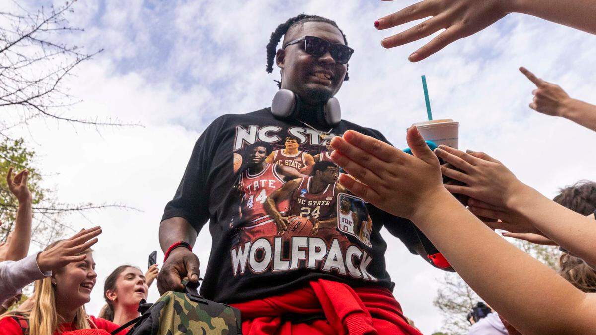 NC.State’s DJ Burns Jr. is greeted by fans as the men’s basketball team departs on a bus Wednesday, April 3, 2024. NC State’s men’s basketball team is headed to the Final Four for the first time since 1983.