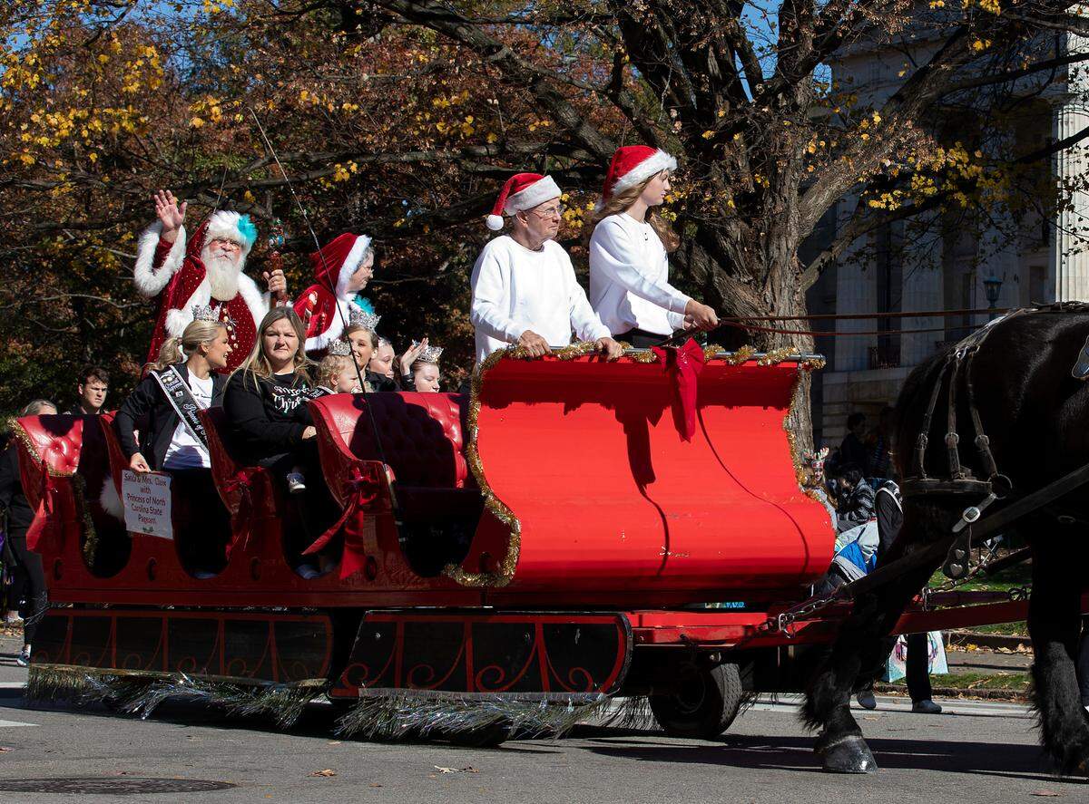 Santa waves from a carriage pulled by horses at the conclusion of the Raleigh Christmas Parade on Saturday, Nov. 18, 2023.